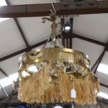 A brass Arts and Crafts chandelier, Gothic style, repair will need to be made to fringes