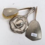 An engine turned silver-backed dressing table mirror and matching brush, and an Art Nouveau silver-