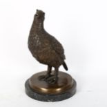 A reproduction patinated bronze sculpture, partridge, unsigned, on black marble base, height 26cm