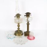 A brass oil lamp with glass font and chimney, 63cm, another, and 4 decorative Vintage glass