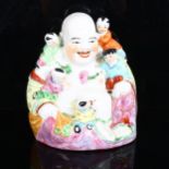 A Chinese famille rose laughing Buddha, with 5 figures of children, height 26cm