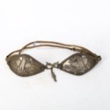 An Indian unmarked white metal bird breastplate, with woven cord, panel length 14cm