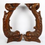 A large pair of carved mahogany dolphin table bases/feet, height 60cm