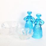 A boxed Orrefors bowl, a pair of figure candlesticks, and another glass bowl