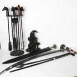 2 reproduction swords, an ebony and bone walking stick, a Mr Punch doorstop, and a companion set
