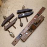 A large woodworking plane, spirit level, and 2 clamps