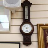 A barometer and thermometer in carved oak, by Negretti & Zambra, 61cm