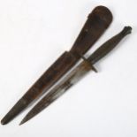 A World War II Commando fighting knife, with ribbed handle and leather sheath, length 29.5cm