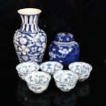 A Chinese blue and white prunus decorated ginger jar and cover, blue and white baluster vase, and