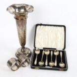 A silver trumpet bud vase, height 23cm, a pair of silver napkin rings, and a cased set of 6 silver