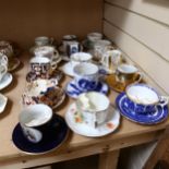 A group of 15 Victorian and later moustache cups and saucers, including Willow pattern and Derby