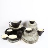 A Vintage Poole Pottery dinner and tea service, with black and white pebble design, including