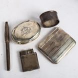 An engine turned silver cigarette case, silver tobacco box, napkin ring, a silver petrol lighter,