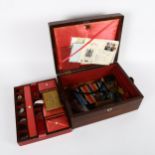 A 19th century rosewood sewing box and contents, including mother-of-pearl spools, a nut etui,