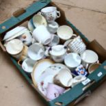 A boxful of moustache cups and various saucers