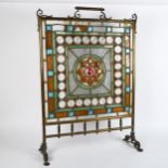 A brass-framed stained-glass fire screen, height 78cm, width 55cm (A/F)