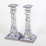 A pair of Portuguese blue and white pottery candlesticks, signed, height 24cm