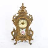 An Art Nouveau gilded spelter foliate mantel clock, with printed porcelain panel, height 28cm,