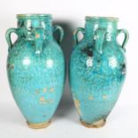 A pair of large Hamadan turquoise glaze pottery oil jars (1 A/F), height 54cm