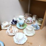 A group of 12 Victorian and later moustache cups and saucers, including Victoria's Diamond Jubilee