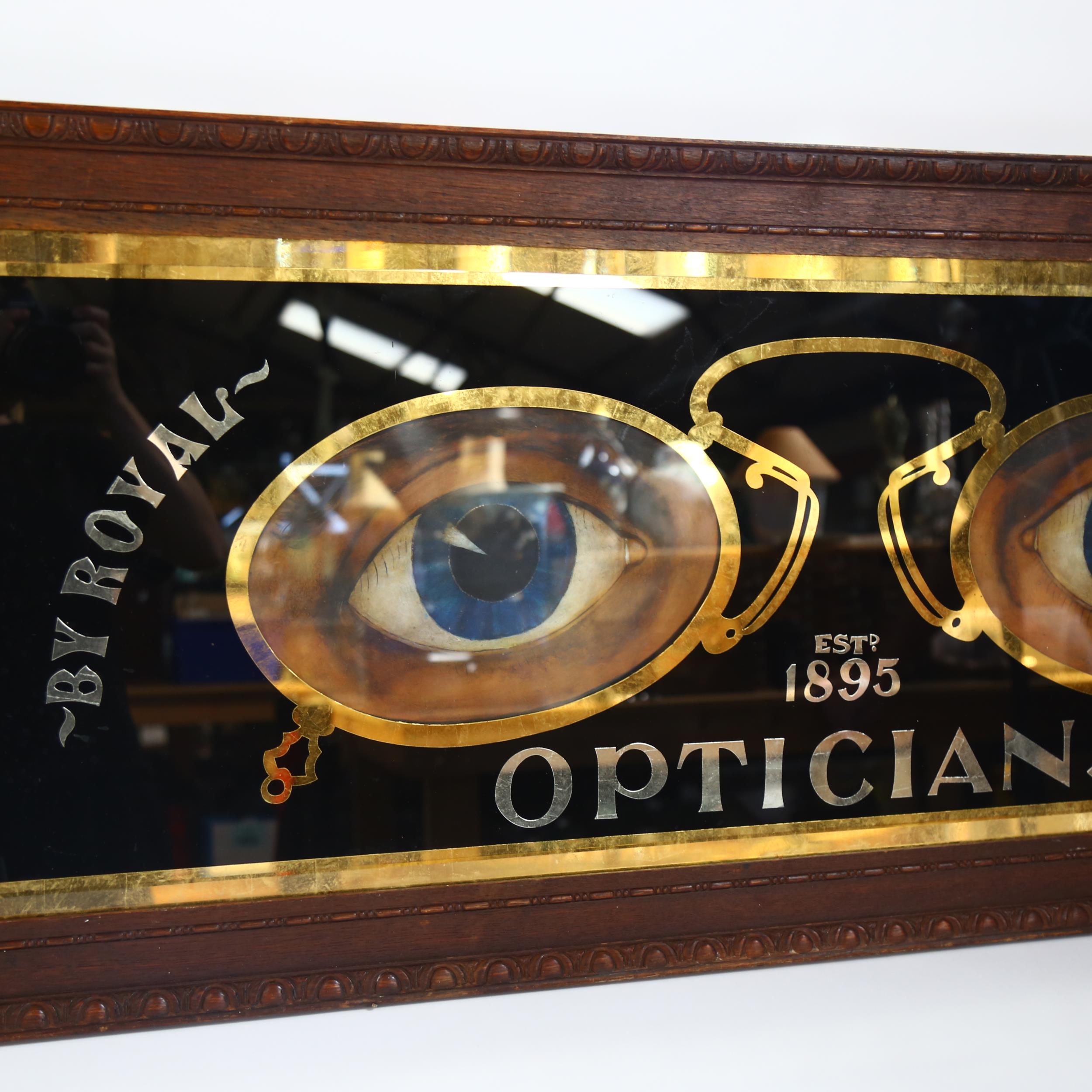 A large Optician's advertising sign, in carved mahogany framed, overall 54cm x 135cm - Image 2 of 2