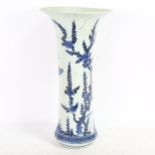 A Chinese blue and white beaker vase, 19th century, decorated in underglaze blue with floral sprays,