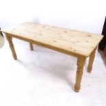 A pine farmhouse kitchen table on turned legs, L183cm, H75cm, D77cm