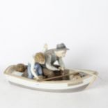 Lladro sculpture of a boy and man fishing from a boat (A/F), length 37cm