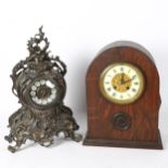 An Antique style cast-metal clock, with scrolled surround and quartz movement, height 38cm, and
