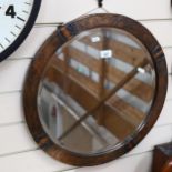 An Arts and Crafts hammered copper-framed circular bevel-edge wall mirror, width 53cm