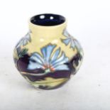 A Moorcroft vase with tube-lined blue floral decoration, 8cm