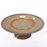 A Middle Eastern brass and copper tazza, with floral engraved decoration, width 26cm