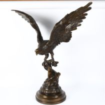 A large reproduction bronzed composition sculpture, eagle perched on branch, unsigned, height