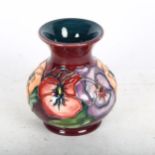 A Moorcroft tube-lined vase with pansy decoration, 9.5cm, boxed