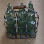 A Vintage bottle carrier and 6 green glass bottles