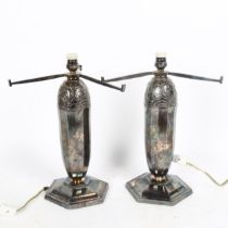 A pair of Art Deco silver plated table lamps, relief embossed decoration with octagonal bases,