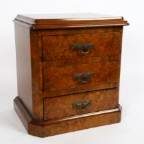A burr-walnut and mahogany table-top apprentice chest of drawers, with brass drop handles, W29cm,