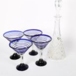 A set of 4 cocktail glasses, with applied blue glass decoration, and a decanter and stopper