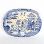 An English blue and white chinoiserie strainer, 38cm x 28cm
