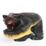 A large Eastern carved and painted bear with fish sculpture, length 40cm, height 24cm