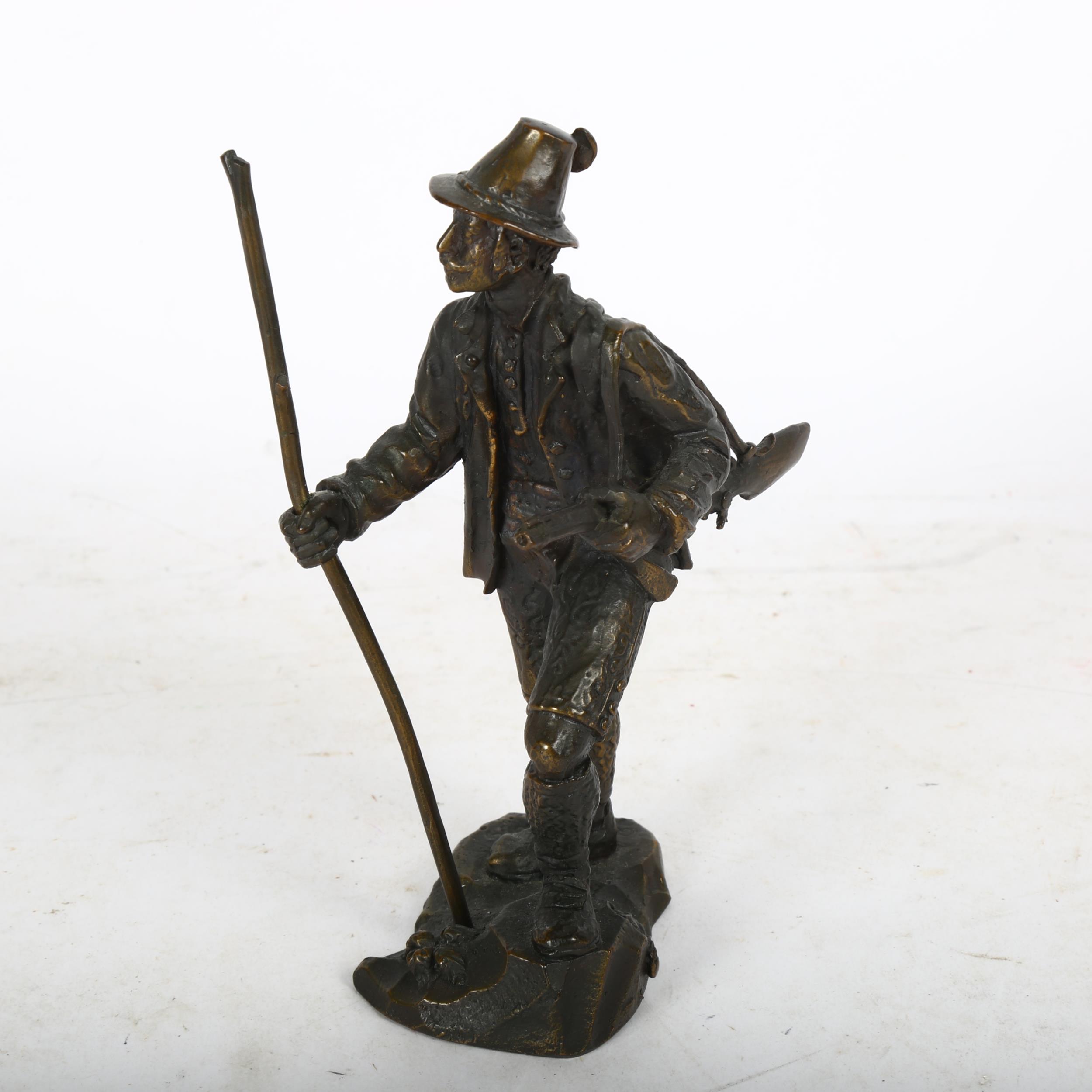 Bronze sculpture of a European huntsman with rifle and staff, height 15cm