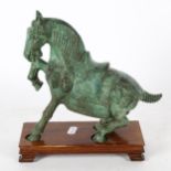 A Tang style verdigris bronze horse, height 23cm