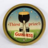 A Vintage Guinness Time Thirst prize wall clock, printed by Reginald Corfield Ltd, with pine cone