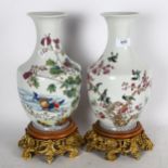A pair of decorative Chinese vases with bird designs, on gilded cast-metal plinths, height 38cm