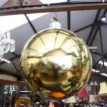 A large decorative Christmas bauble, gold in colour, diameter 52cm