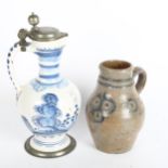 A 18th/19th century German Bayreuth jug with pewter mounts, and a 19th century stoneware jug (2),