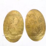 A pair of oval bronzed plaques, with relief decoration, with LG monogram, length 28cm