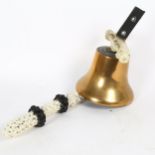 A polished bronze bell, with mount and painted rope-handled clapper, unmarked, diameter 19cm