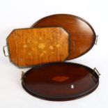 A pair of late Victorian mahogany oval brass-handled serving trays, with decorative shell inlay, and
