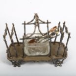 A Victorian silver plated toast rack with central butter dish, on cast-branch feet